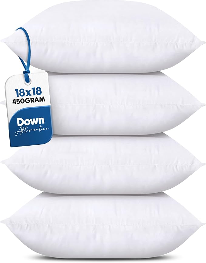A stack of four white square pillows from the Utopia Bedding Throw Pillows (Set of 4, White), 18 x 18 Inches Pillows shown with a simple product tag.