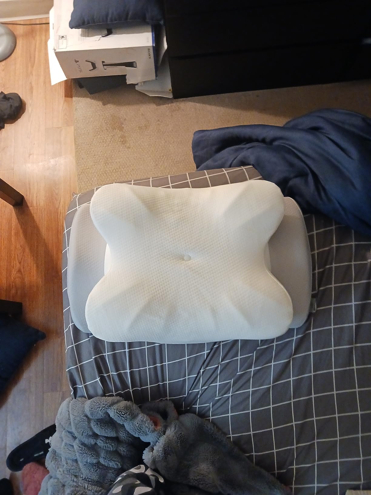 A bed with a Pulatree Pillow for Back Stomach Sleeper on it, alongside a dresser, showcasing a cozy bedroom setup.