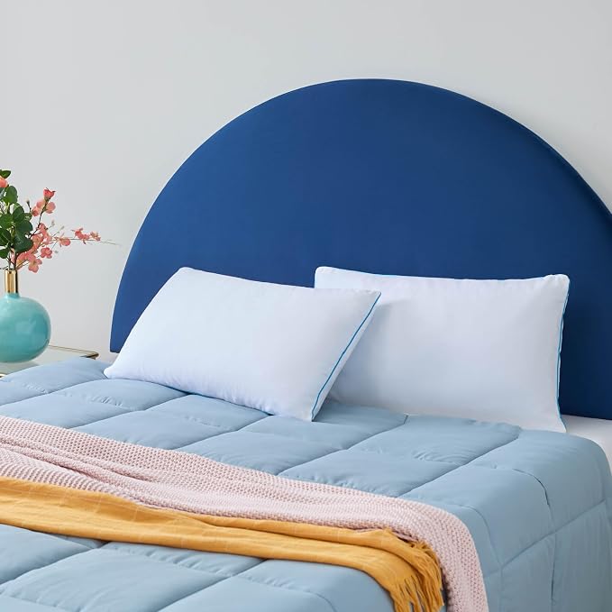 Two LINENSPA Memory Foam Pillows resting on a vibrant, colorful rug, creating a cozy and inviting atmosphere.