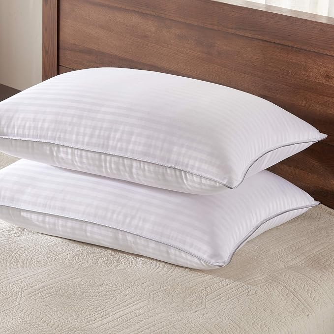 Two Basic Beyond King Size Bed Pillows resting on a bed with a wooden headboard, creating a cozy and inviting look.