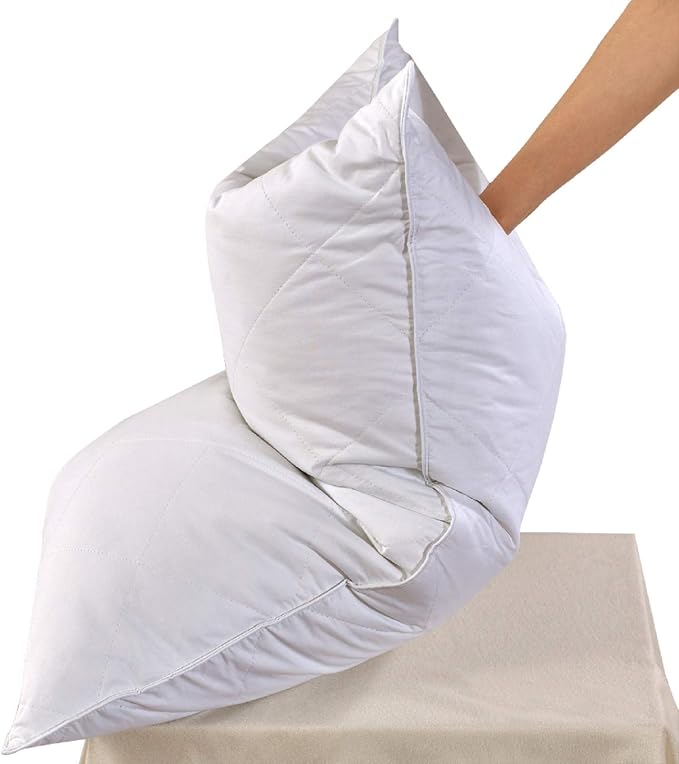 A person holds a pillow on a bed, showcasing the comfort of the Three Geese Set of 2 White Goose Feather Bed Pillows.