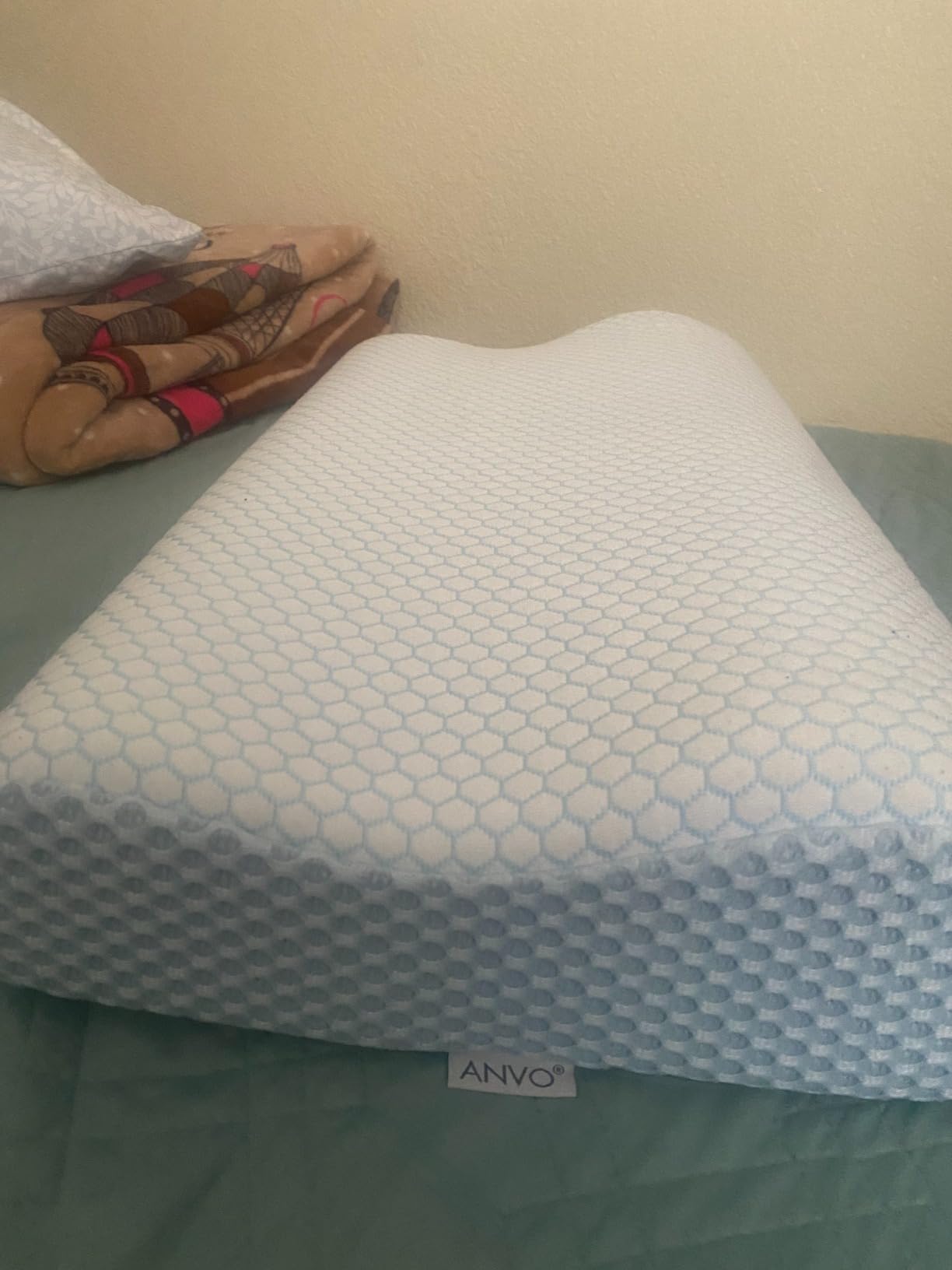 Anvo Memory Foam Pillow placed on a couch, appearing like a standard pillow, showcasing its comfort and design.