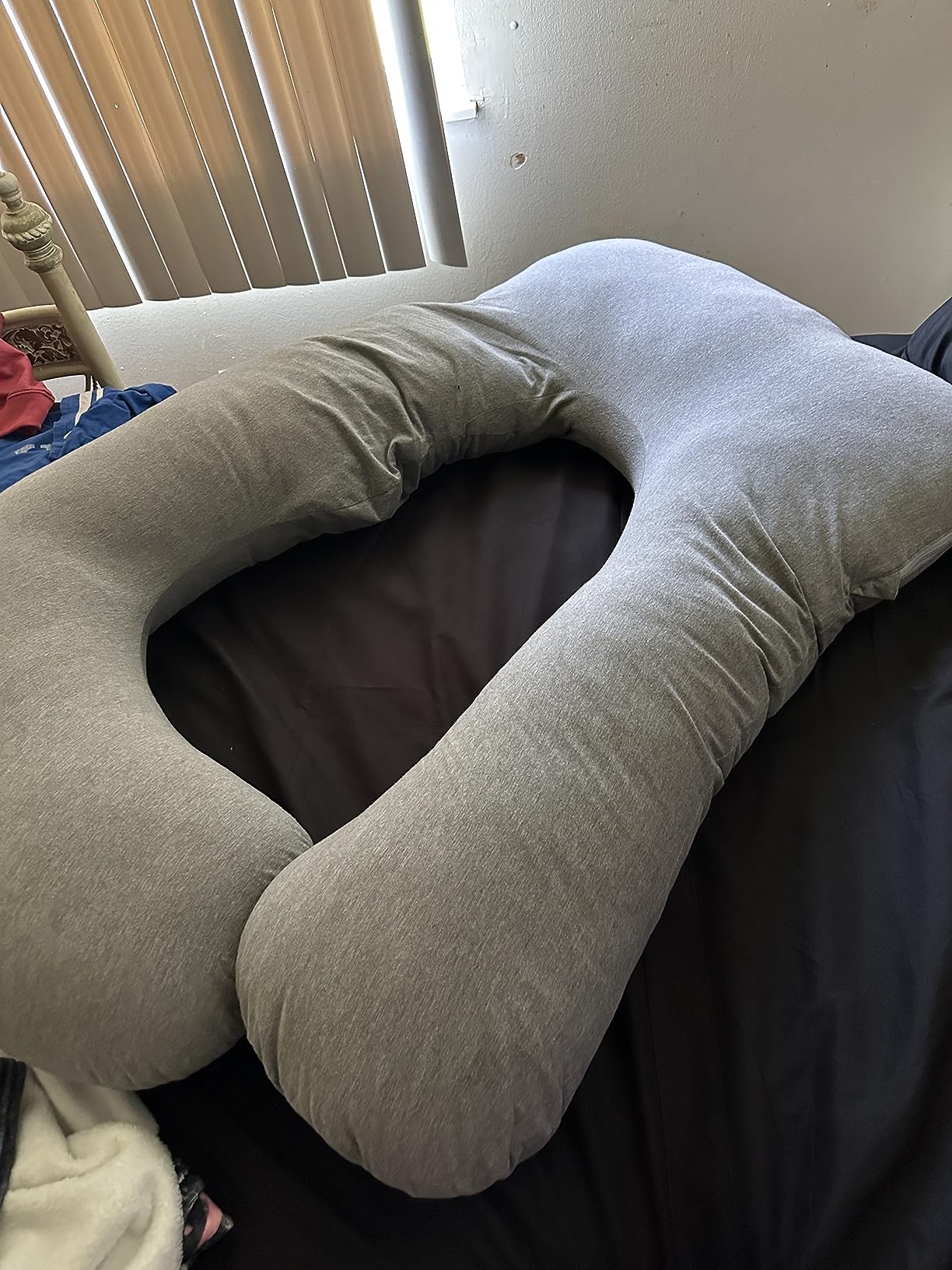 A soft Elover Pregnancy Pillow resting on a neatly made bed, showcasing its comfort and support for restful sleep.